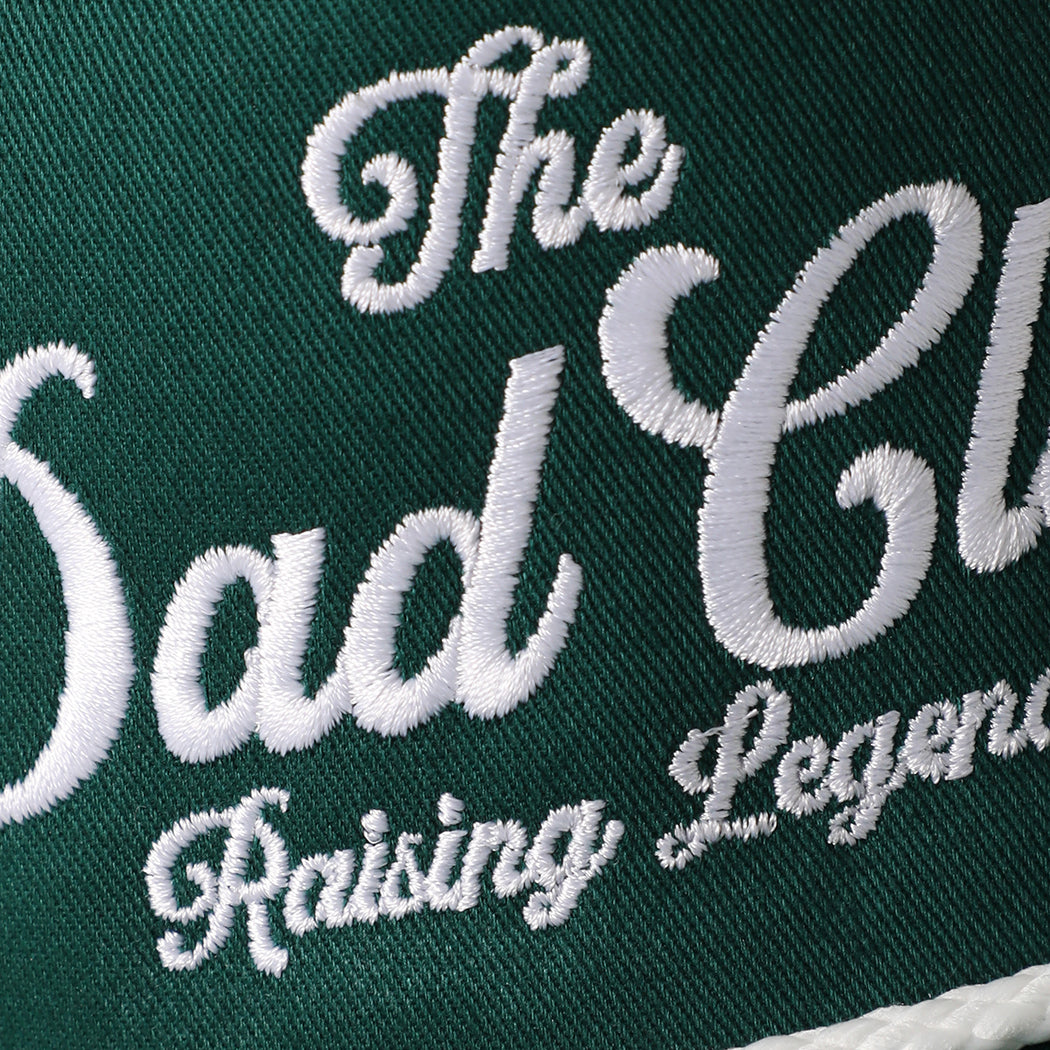 The Dad Club Raising Legends rope trucker hat in dark green and white, side view