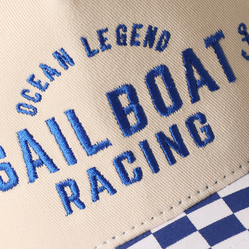 Ocean Legend Sailboat checkered brim trucker hat in blue, side view