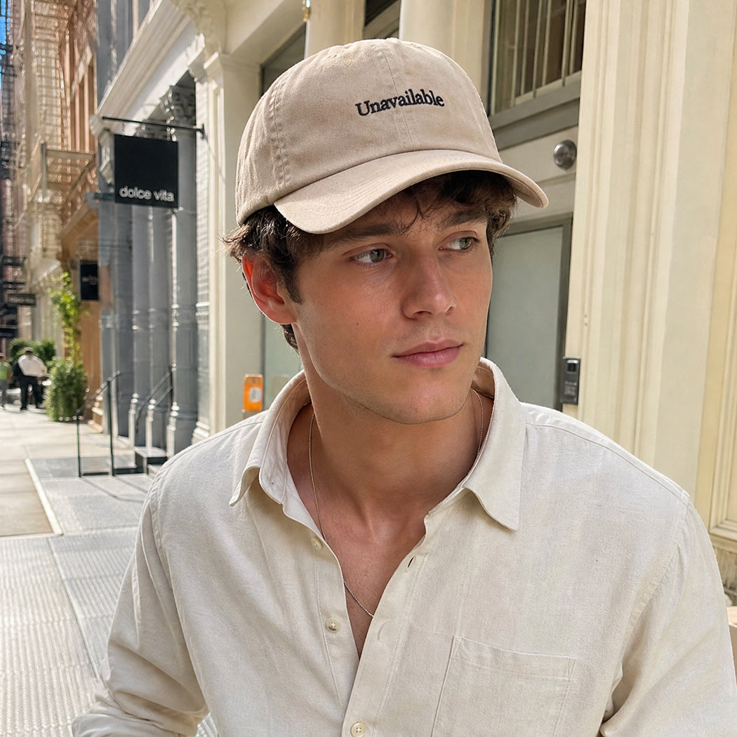 Model wearing Unavailable embroidered baseball cap