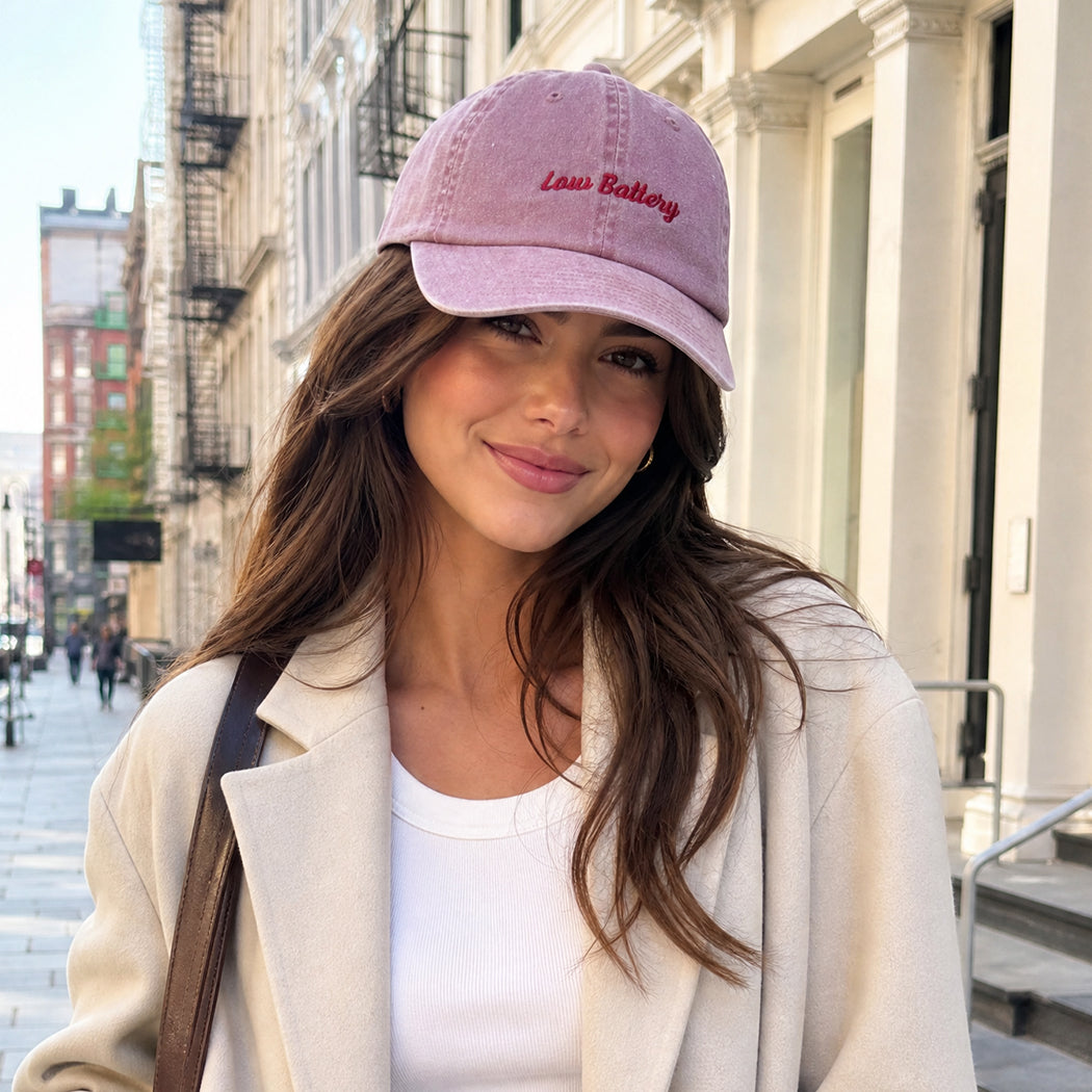 Model wearing Low Battery embroidered baseball cap