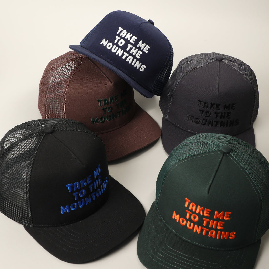 Take Me To The Mountains embroidered trucker hat, front view alternate angle