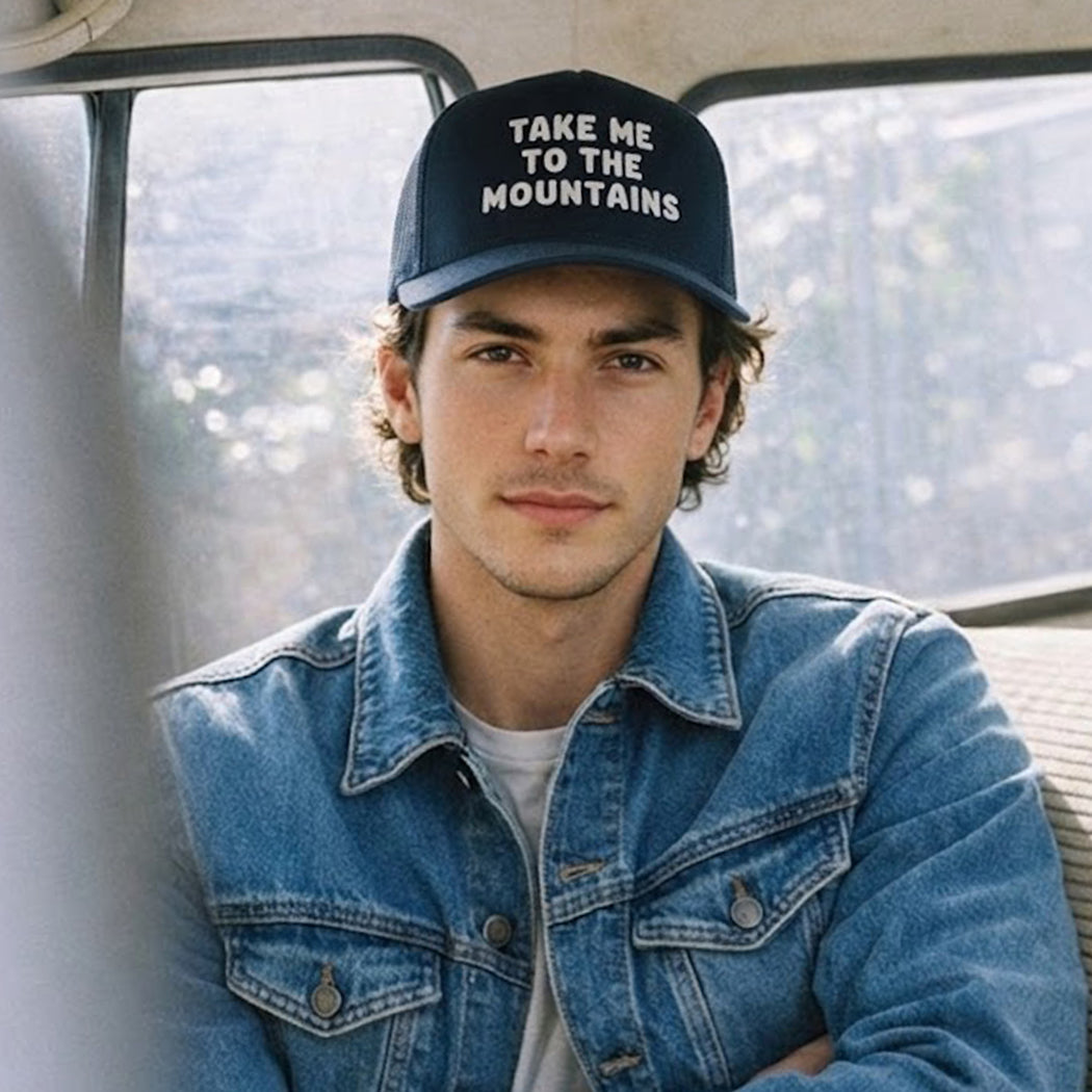 Take Me To The Mountains embroidered trucker hat, front view