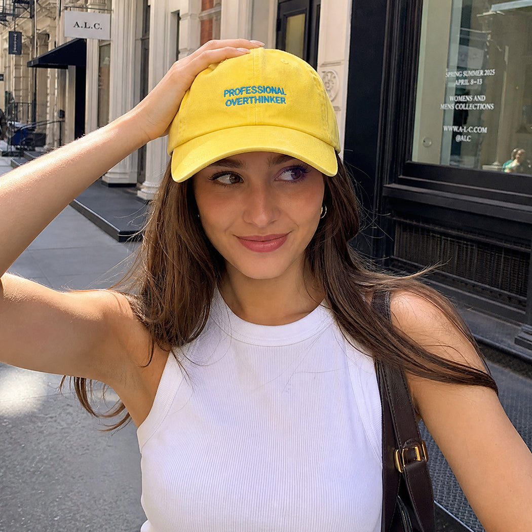 Model wearing Professional Overthinker washed baseball cap