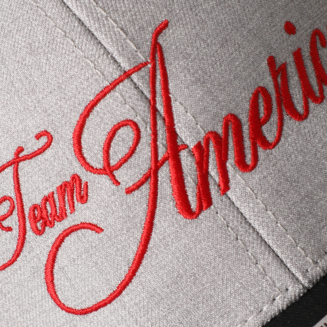 Team America Script mesh back trucker hat in black and heather grey, side view