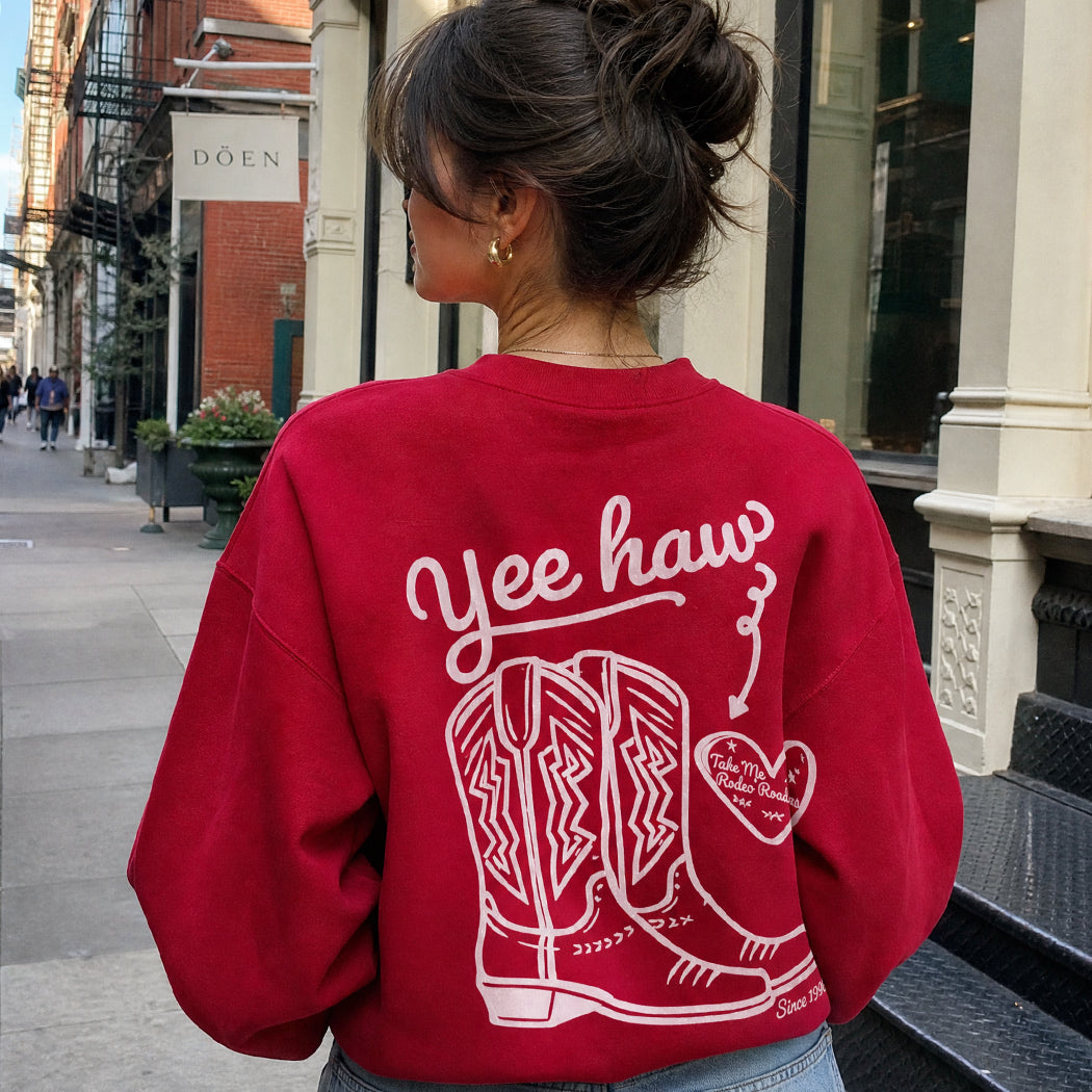 Model wearing Yeehaw Not My First Rodeo western graphic sweatshirt