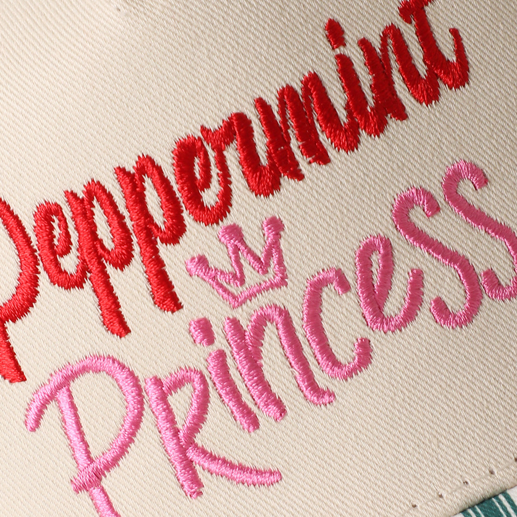 Peppermint Princess holiday brim trucker hat in green, angled view