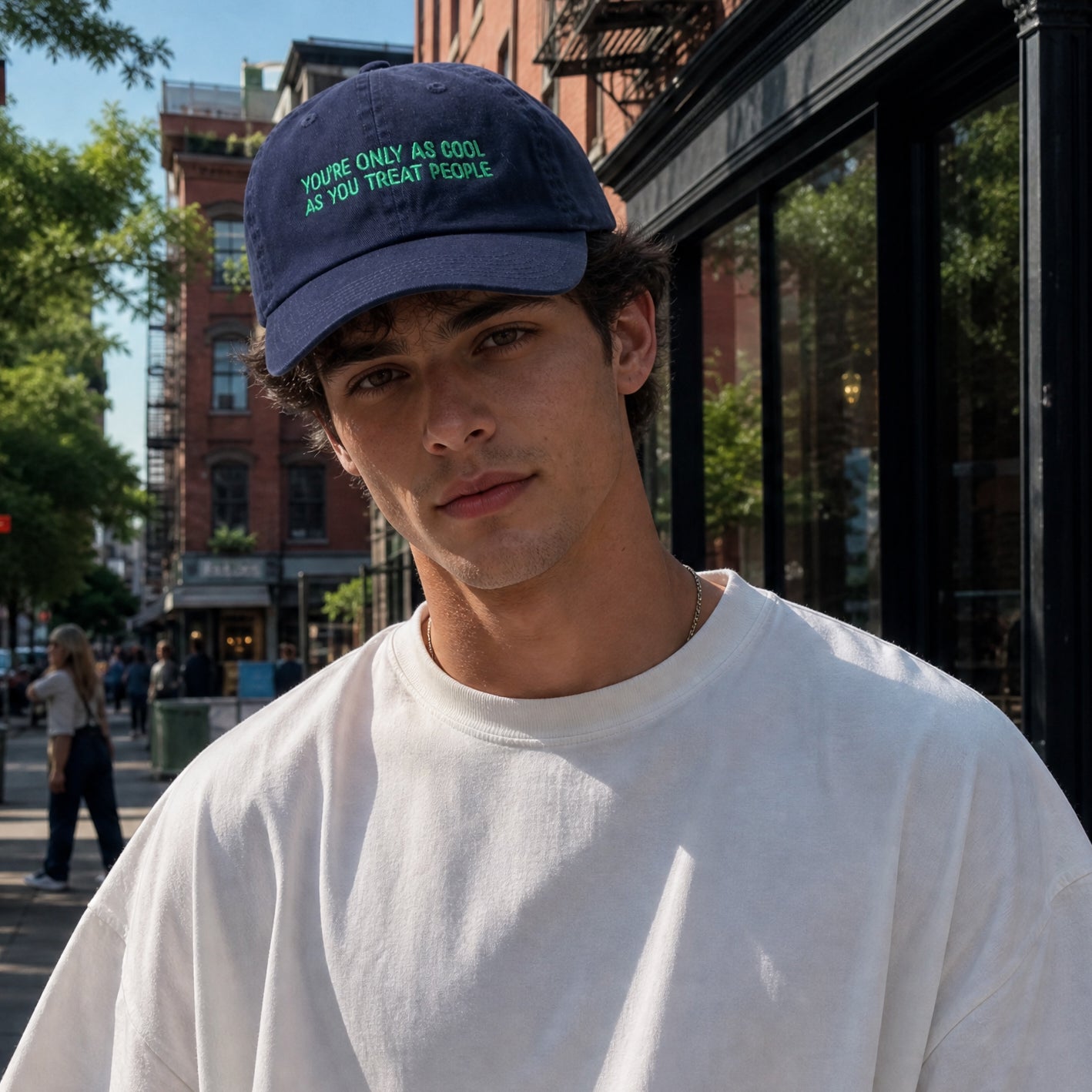 Man wearing You're Only As Cool As You Treat People embroidered cap
