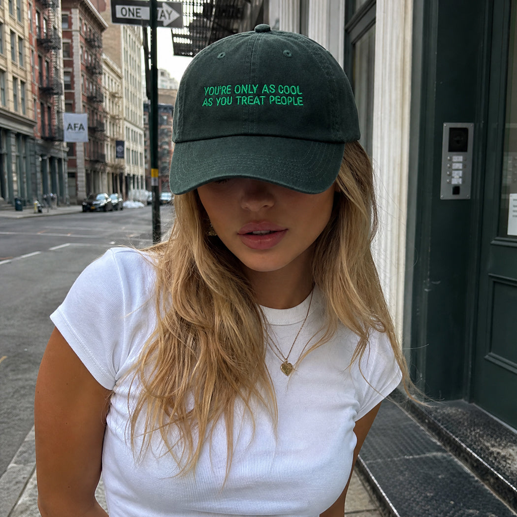 Model wearing You're Only As Cool As You Treat People embroidered cap