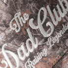 The Dad Club Raising Legends camo trucker hat in dark camo, side view