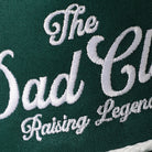The Dad Club Raising Legends rope trucker hat in dark green and white, side view