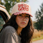 God Is Good embroidered checkered brim trucker hat, front view