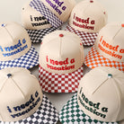 I Need A Vacation checkered brim trucker hat, all color options