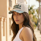 I Need A Vacation embroidered checkered brim trucker hat, front view