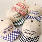 Hard Fought Hallelujah checkered brim trucker hat shown in all color options