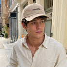 Model wearing Unavailable embroidered baseball cap