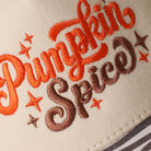 Pumpkin Spice printed brim trucker hat with zebra print brim, angled view