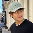Model wearing Mentally Elsewhere embroidered baseball cap