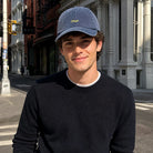 Model wearing Meh embroidered baseball cap