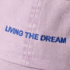 Living the Dream embroidered baseball cap in lilac, side view