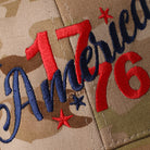 Flexfit YP America 1776 camo trucker hat in multicam khaki, side view