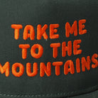 Take Me To The Mountains trucker hat in dark green, side view