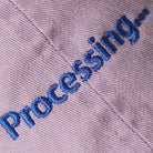 Processing embroidered baseball cap in lilac, side view