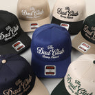 The Dad Club Raising Legends embroidered trucker hat, all color options