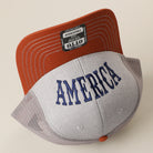 America Upside Down mid profile trucker hat in orange and heather grey, back view