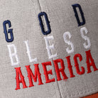 God Bless America mid profile trucker hat in orange and heather grey, side view