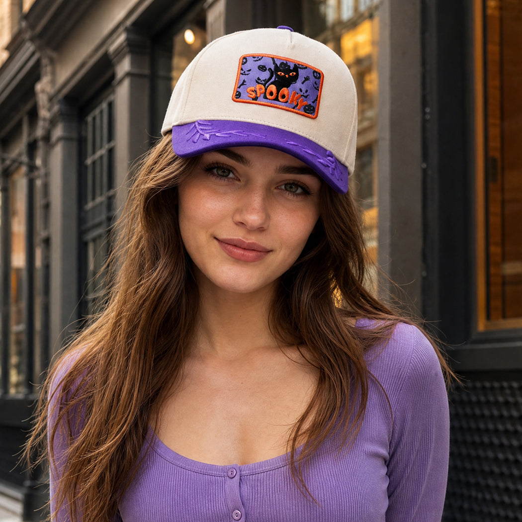 Spooky black cat embroidered patch leaf brim trucker hat, front view