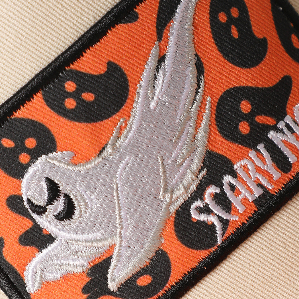 Scary Night ghost patch leaf brim trucker hat in orange, angled view