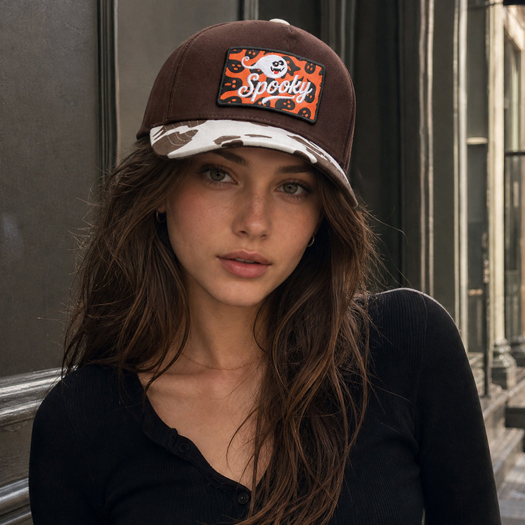Spooky ghost embroidered patch trucker hat with cow-print brim, front view