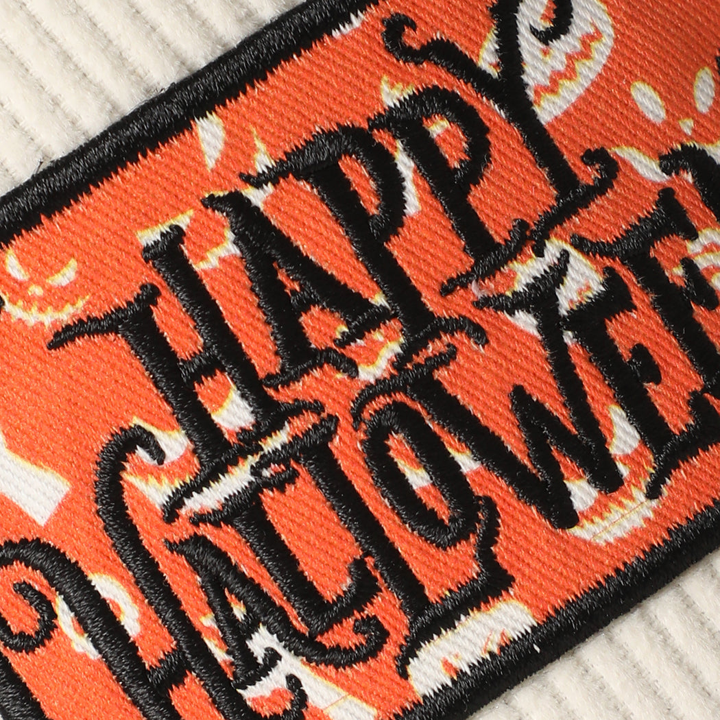 Happy Halloween patch corduroy trucker hat in off-white, angled view