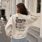 Model wearing Espresso Club graphic sweatshirt in white