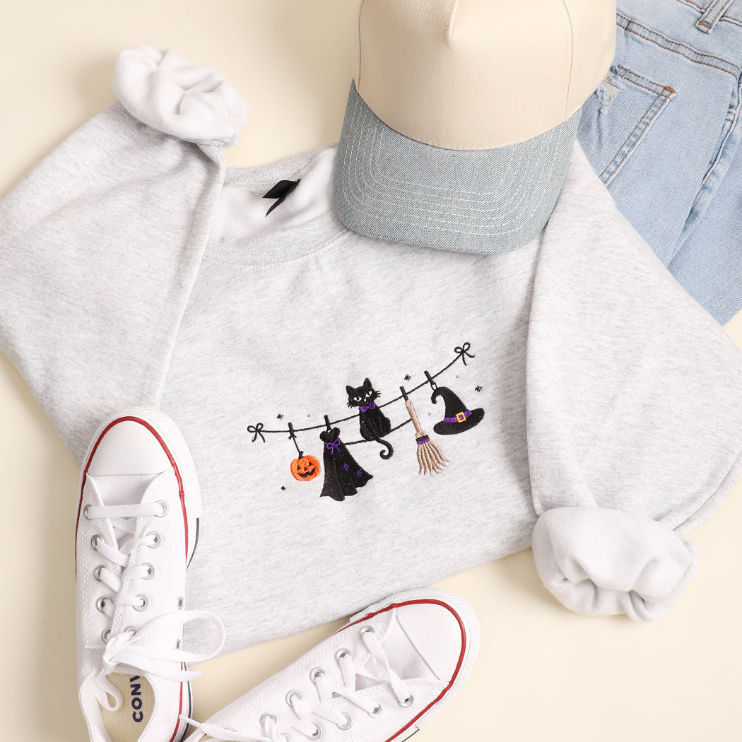 Witchy Halloween clothesline embroidered sweatshirt in ash grey