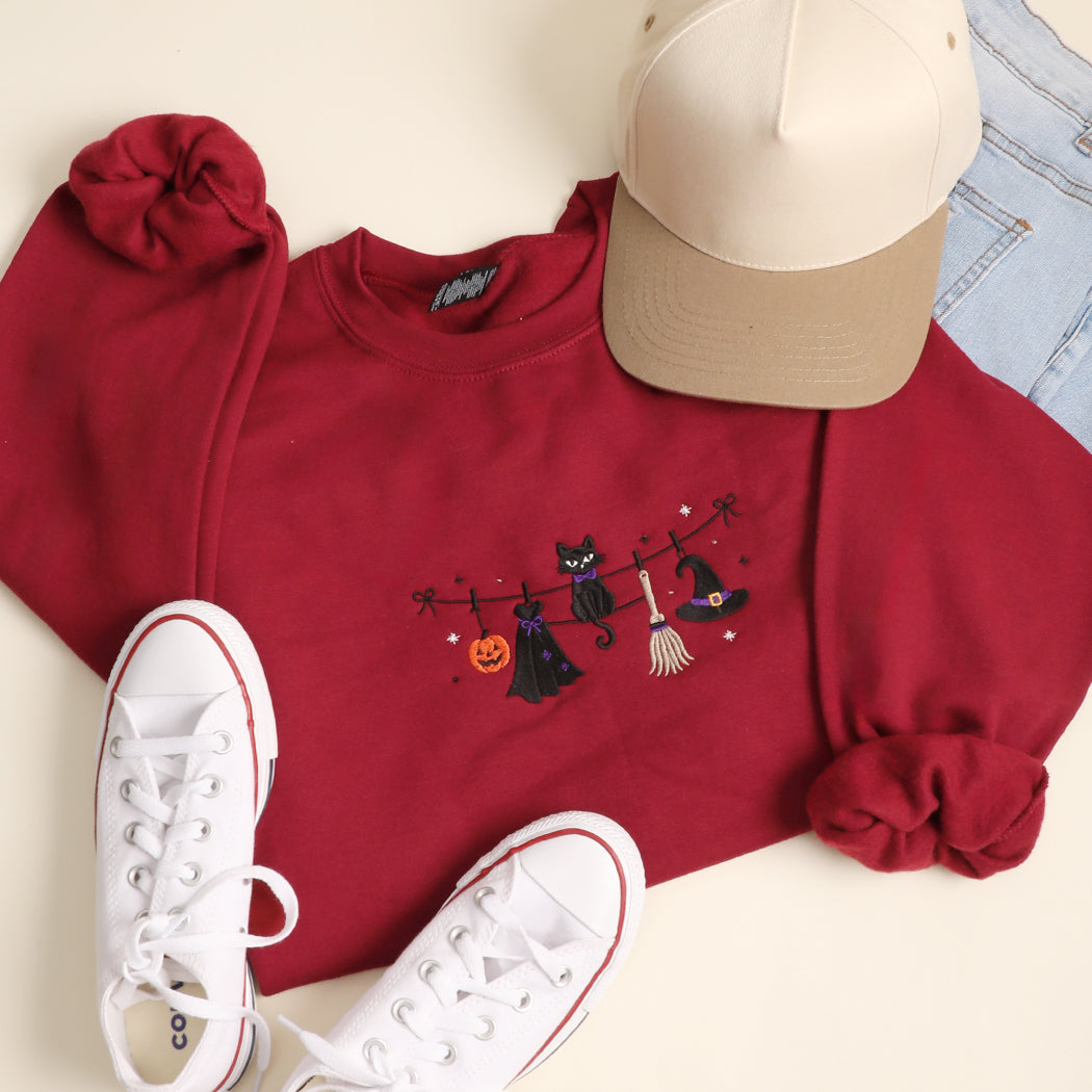 Witchy Halloween clothesline embroidered sweatshirt in garnet