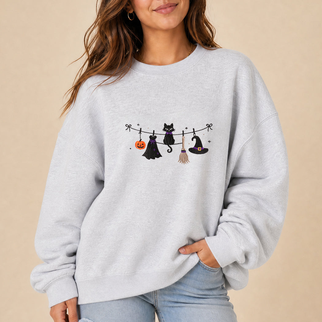 Witchy Halloween clothesline embroidered sweatshirt, front view