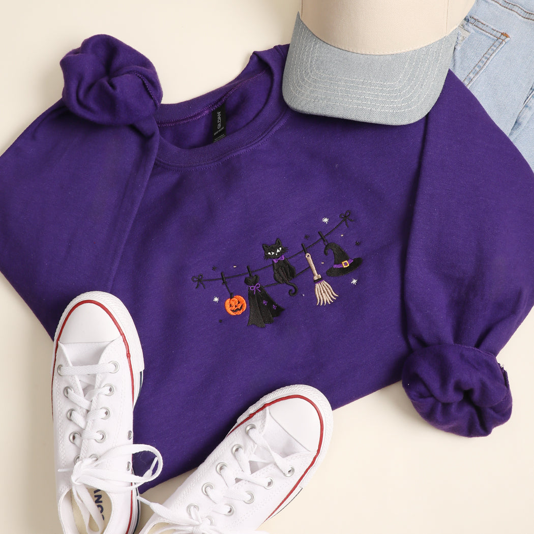Witchy Halloween clothesline embroidered sweatshirt in purple