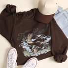 Rest In The Lord flying duck graphic sweatshirt in dark chocolate
