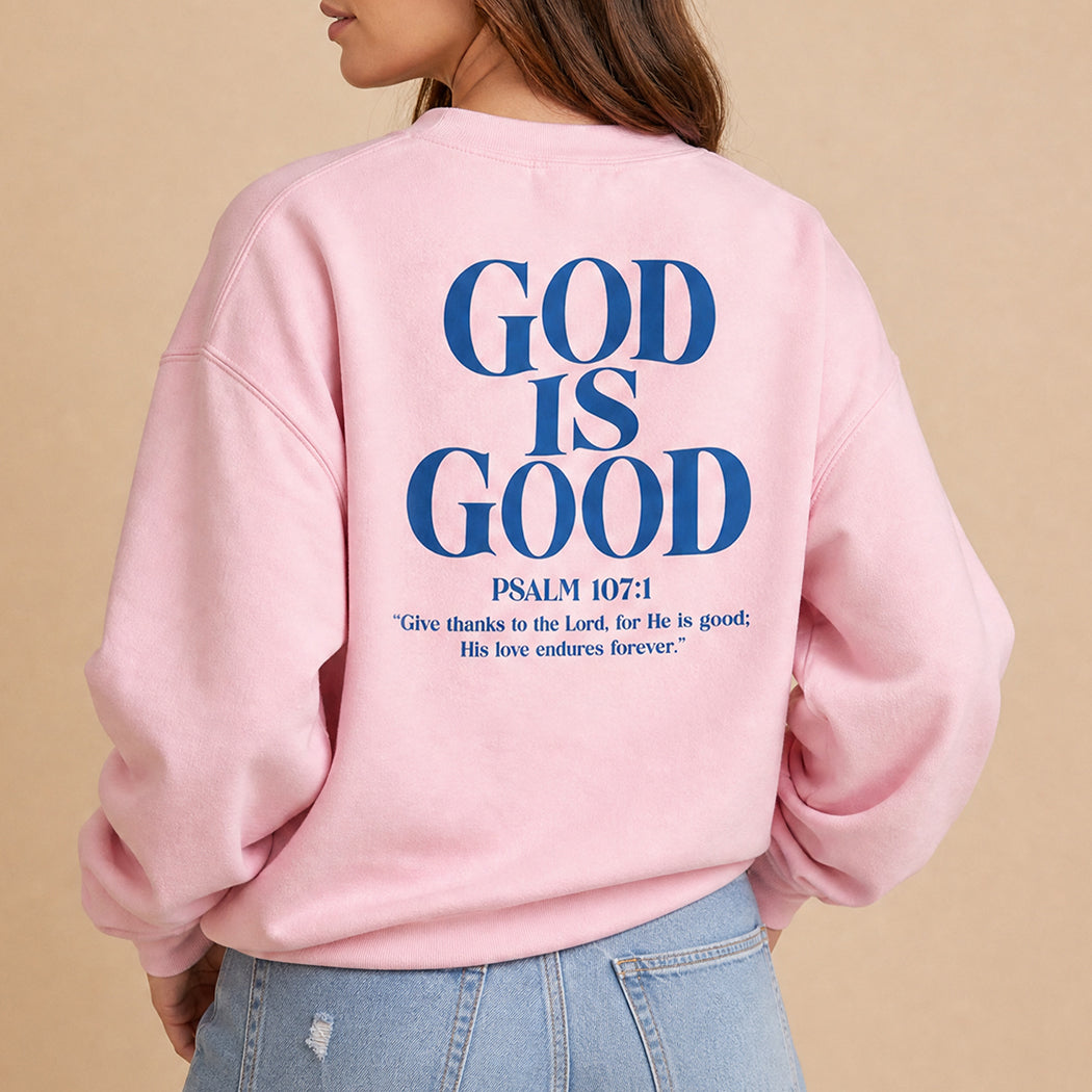 God Is Good Psalm 107:1 graphic sweatshirt in light pink, front view